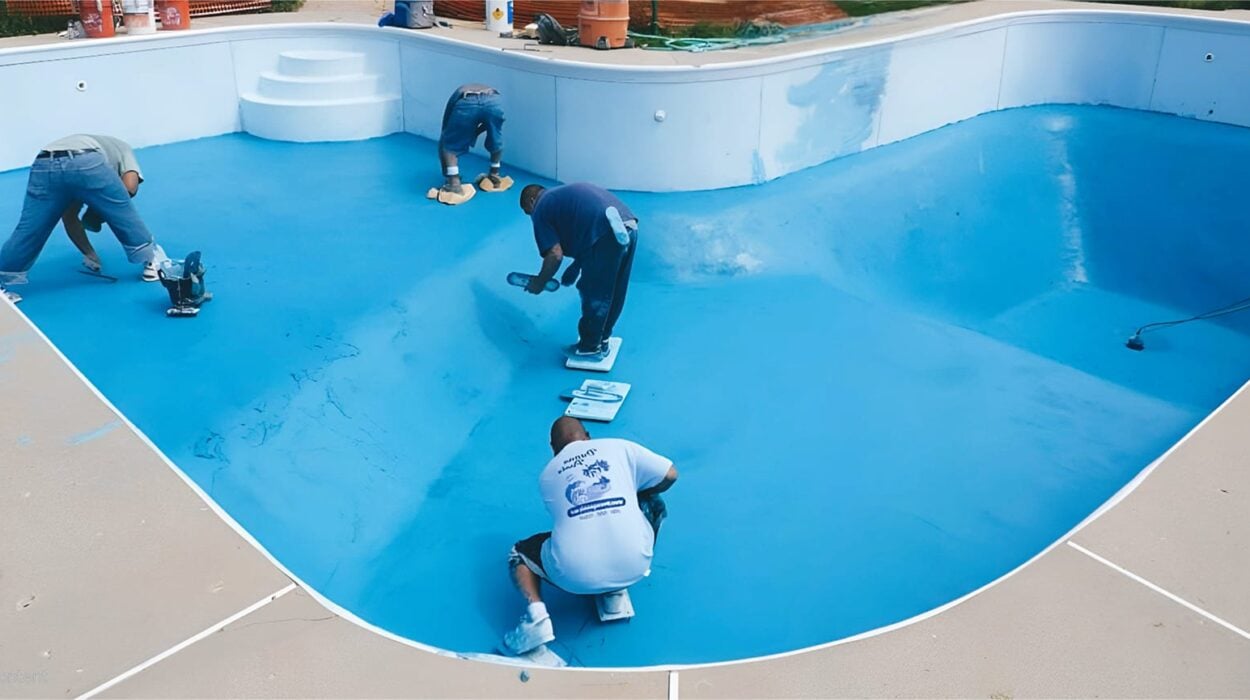 worker resufacing the pool