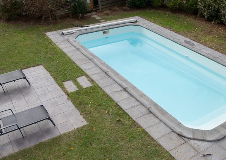 pool concrete deck with landscape and sitting space