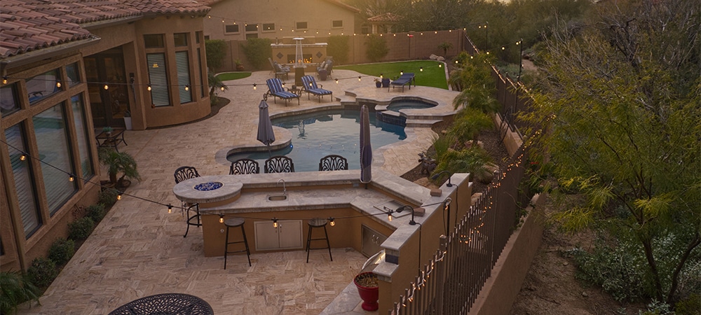 swimming pool, fence, open kitchen, landscape, interlock deck in home backyard