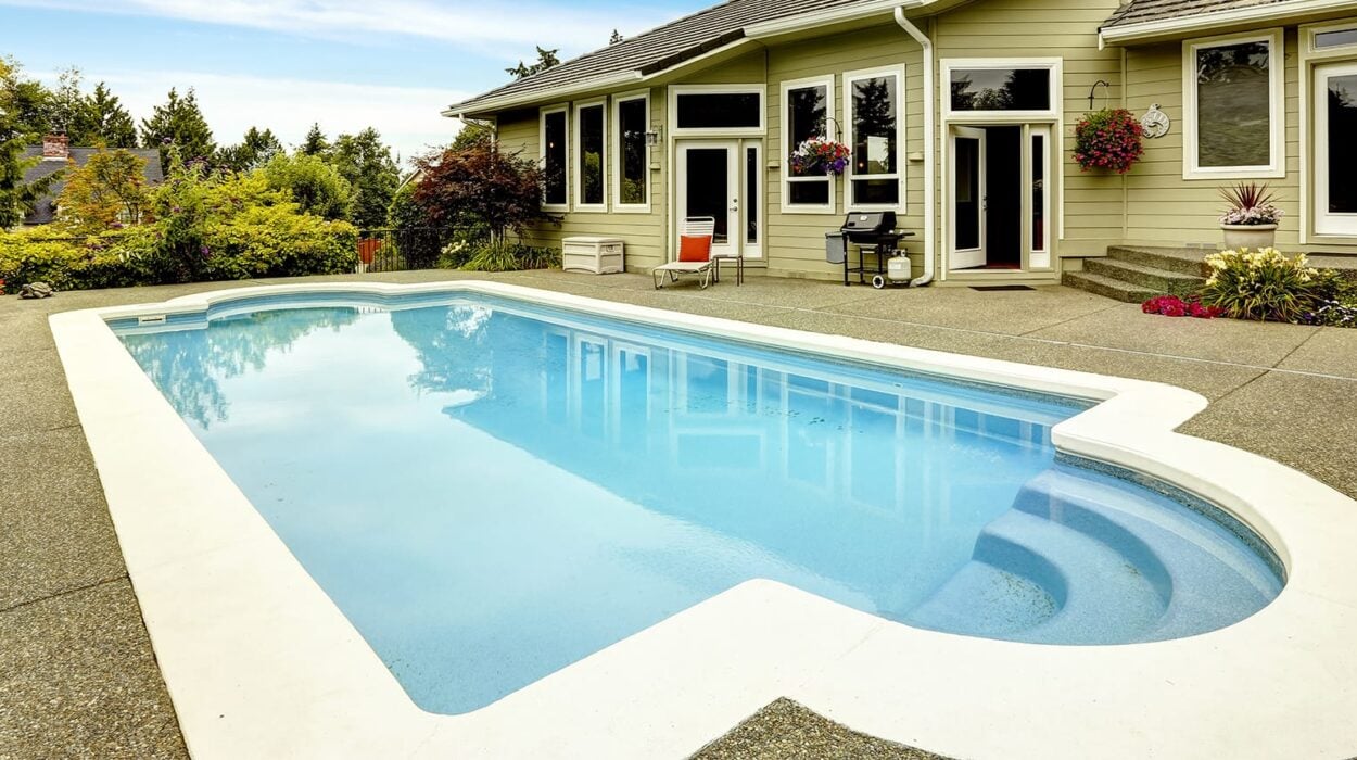 swimming pool with landscaping in the home backyard