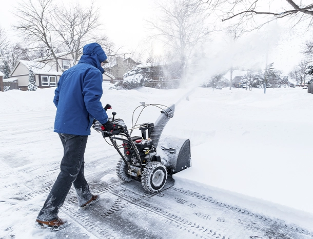 man clearing snow with a snow blower man clearing snow with a snow blower