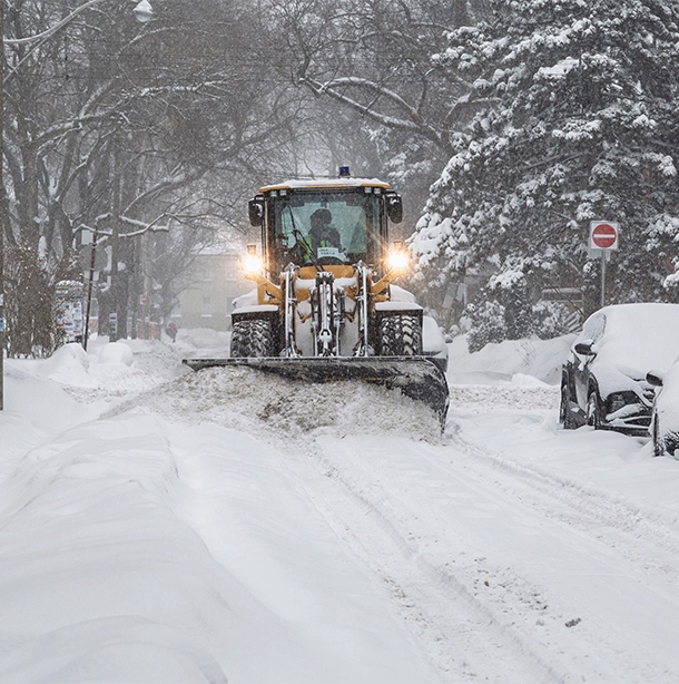 snowplow clearing neighbourhood street during a snowstorm snowplow clearing neighbourhood street during a snowstorm