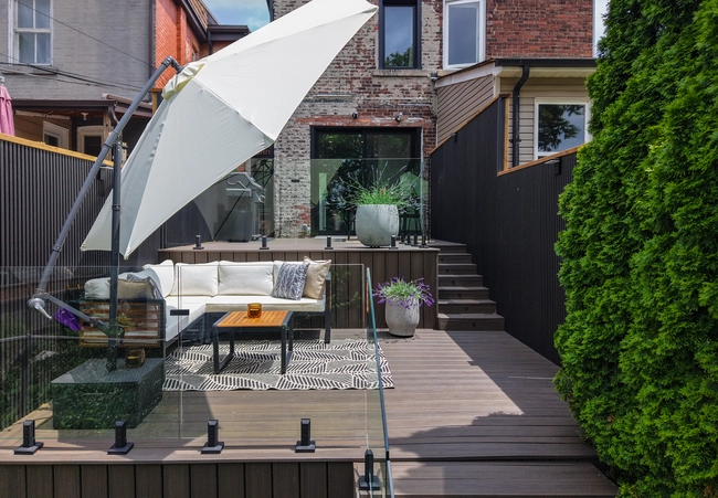 beautiful brand new trex decking with backyard furniture and greenery