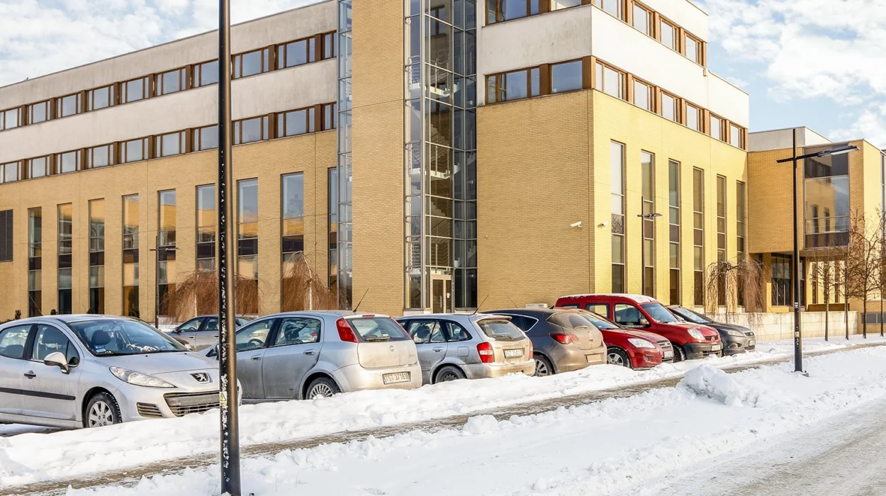 modern office building on bright winter day, snow covered parking area