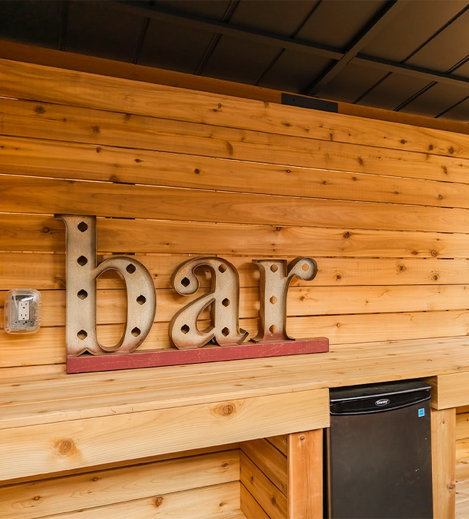 bar writing with lighting feature on wooden wall