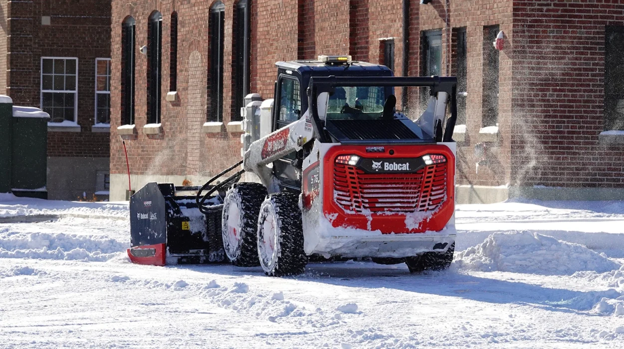 Bobcat Skid-Steer Loader being used to plow snow