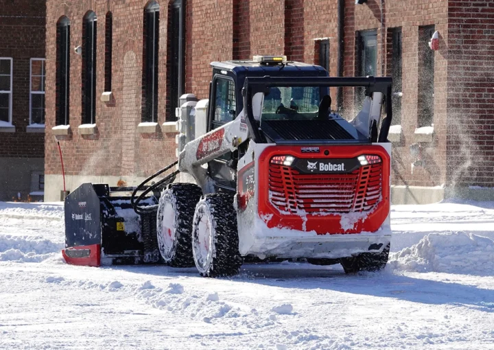 Bobcat Skid-Steer Loader being used to plow snow