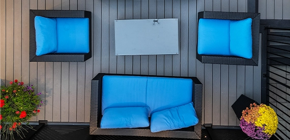coach with blue covers in wooden outdoor deck