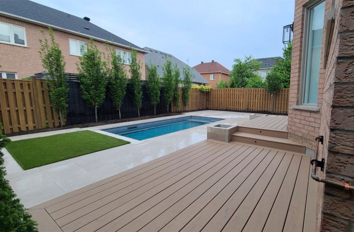 complete yard view, deck, pool, fence, landscaping