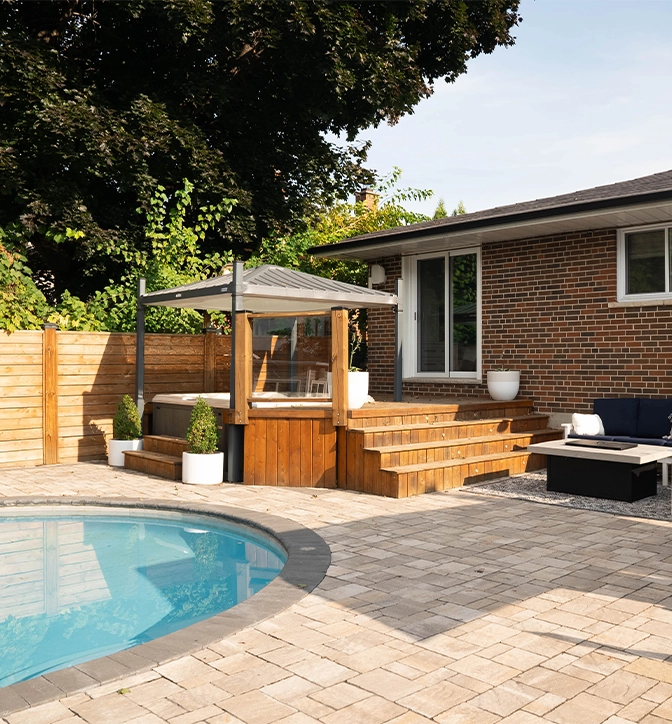 pool with interlocking deck and wooden fence
