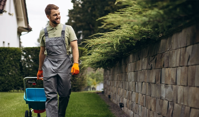smiling gardener looking at plants