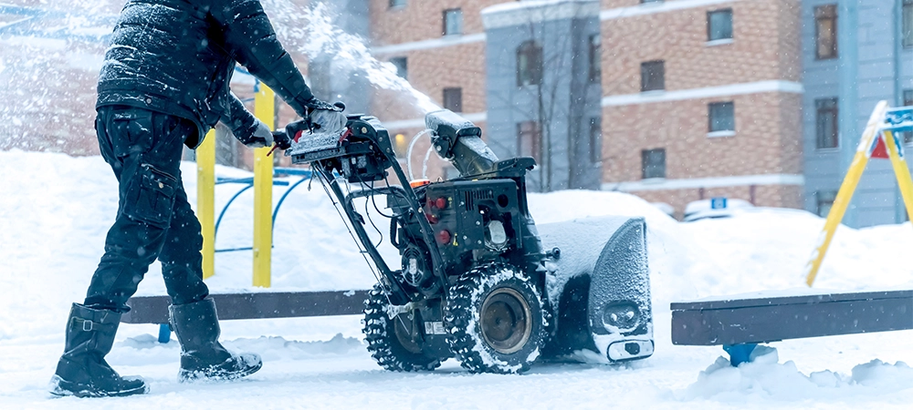 snow blower removes snow in the walkway
