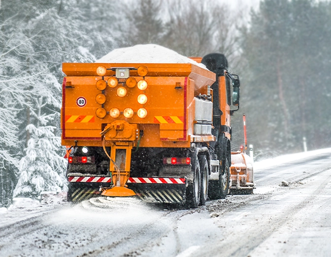 snow management truck and salting on road