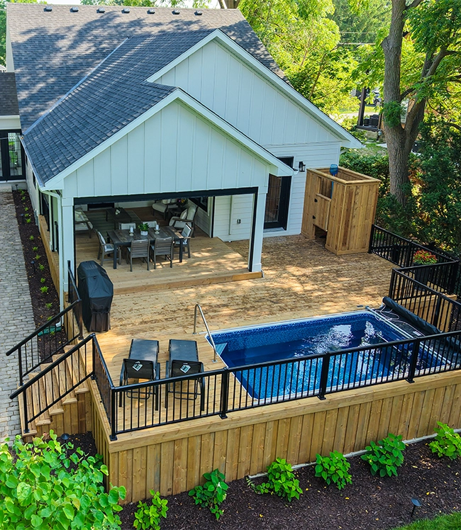 wooden deck with railing and stairs, built-in pool in home backyard wooden deck with railing and stairs, built-in pool in home backyard