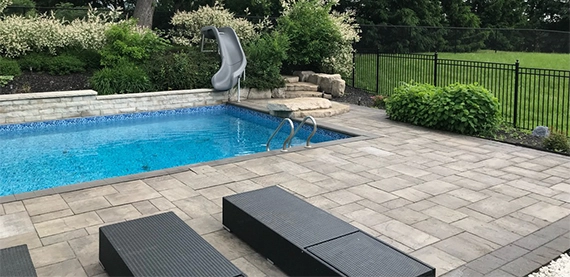 pool with interlock deck in open space covered with aluminium fence