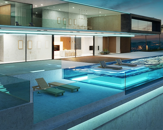 lighting in acrylic and glass walled pool, pool space covered with glass, in front of luxury home, large glass walls