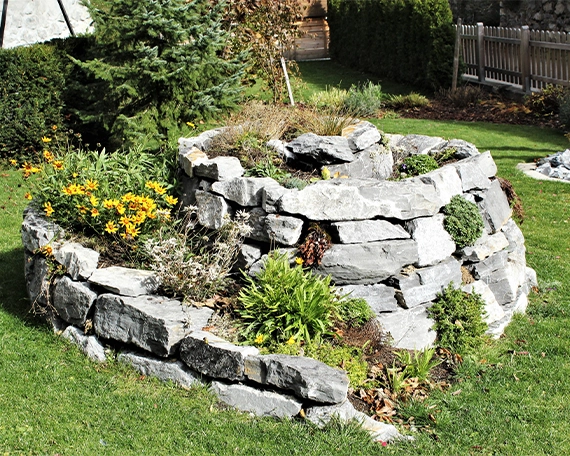 custom round design armour stone retaining wall