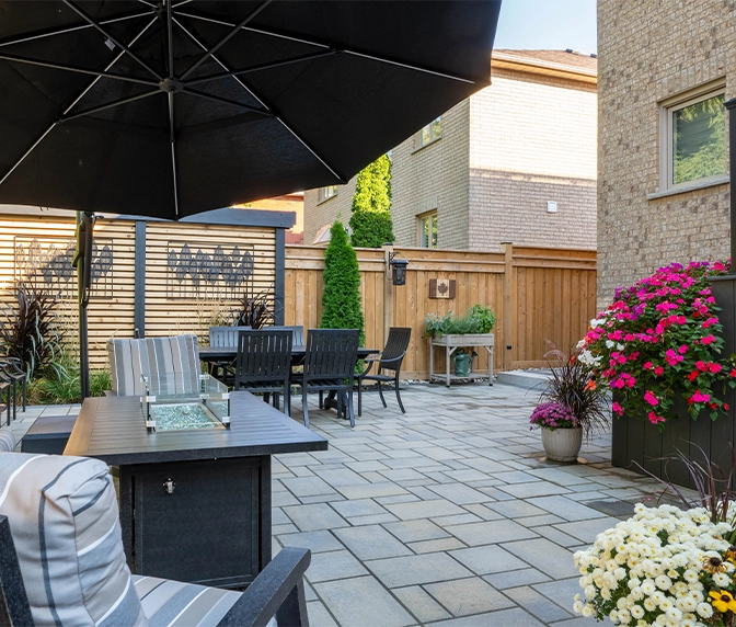 backyard space setup for gathering, interlocking floor, flowers decoration in pots, fence and privacy screen