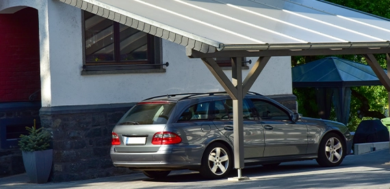 carport on home side Carport of varnished wood in Front of a residential Building
