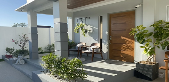 side view of home front porch, sitting setup, plants in pot
