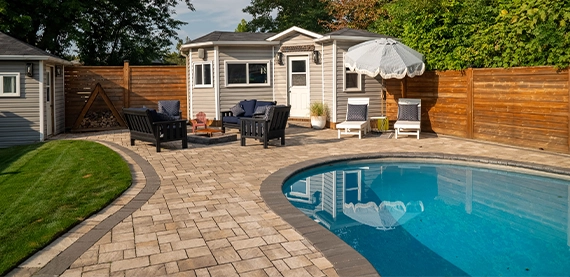 interlocking patio and surface around pool with sodding