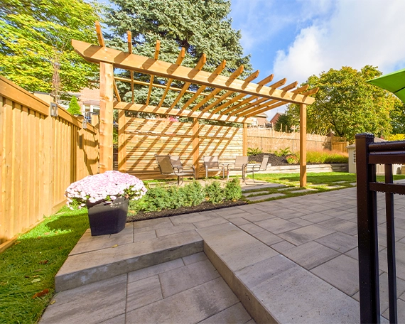 custom cabana with fence on yard and interlocking surface