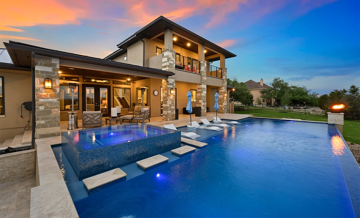 home back yard concrete pool with steps home backyard full view, luxury infinite concept concrete pool with walkway step, lighting on and firepit in lawn