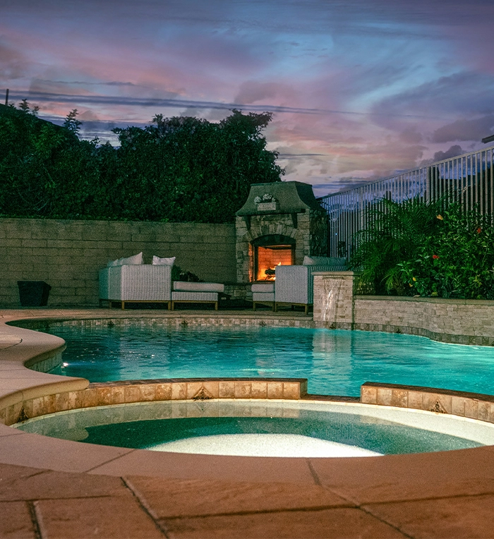 hot tub and swim spa with lighting, sound and waterfall features in backyard