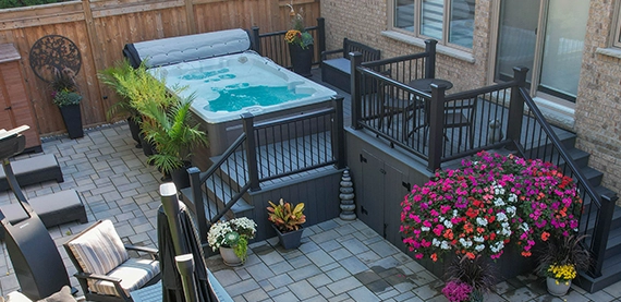 backyard view, hot tube and deck with steps and interlocking floor