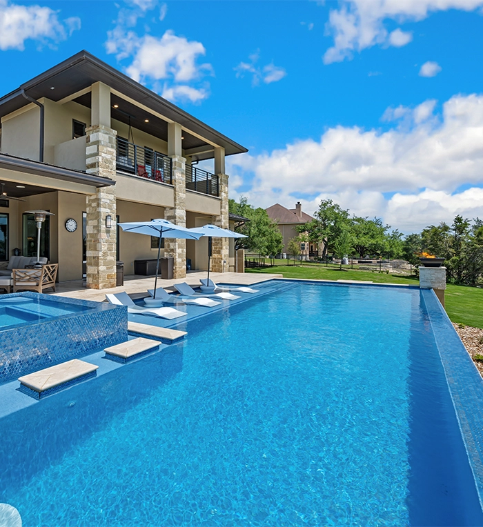 infinite pool in front of luxury home yard