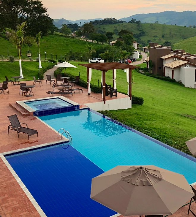 infinity swimming pool in home backyard, beautiful valley view, full yard setup for gathering