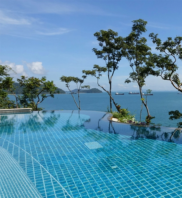 infinity swimming pool blue tiles and beautiful sea view