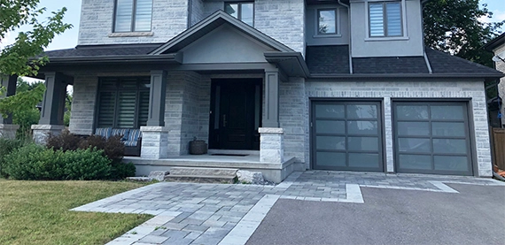 luxury home with well-designed custom interlocking driveway