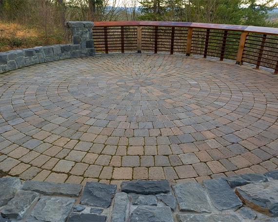 round shape interlock patio and small surrounding stone wall
