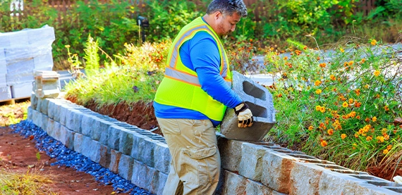 professional man installing interlocking blocks wall