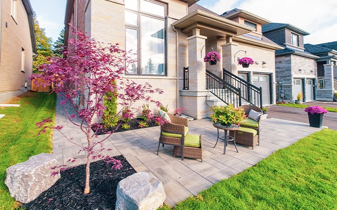 landscaping around patio and seating area in front of home
