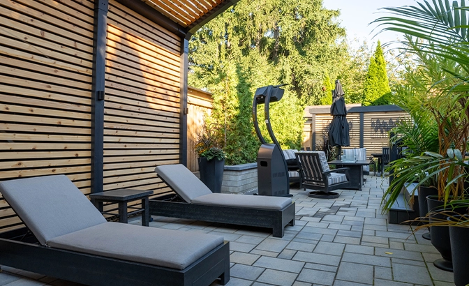 landscaping with seating area and interlocking floor in backyard