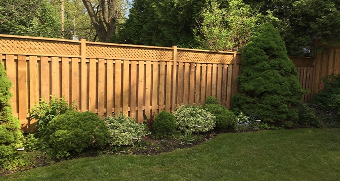 wooden fence with landscaping in lawn