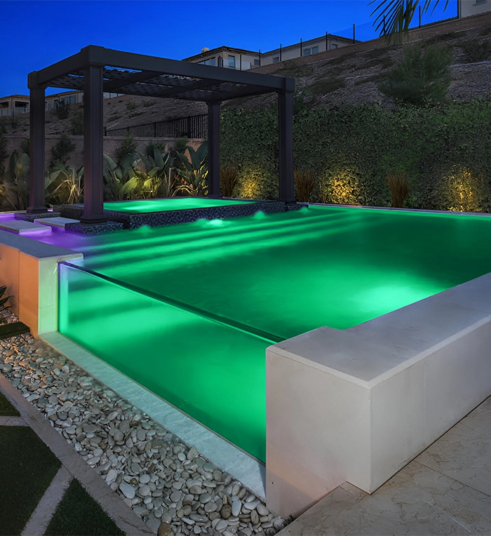 lighting feature in acrylic and glass walled pool, covered with concrete wall, cabana on plunge pool