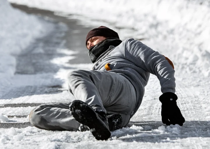 Injured man lying on the road, downfall and accident on winter season, black ice