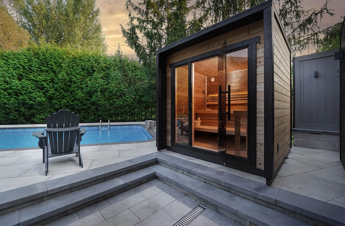 multi level interlocking surface around pool in backyard, close up view of sauna