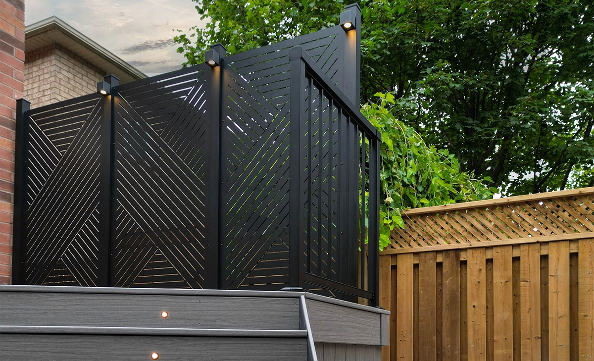 outdoor privacy screen with lighting feature on deck and background fence wall