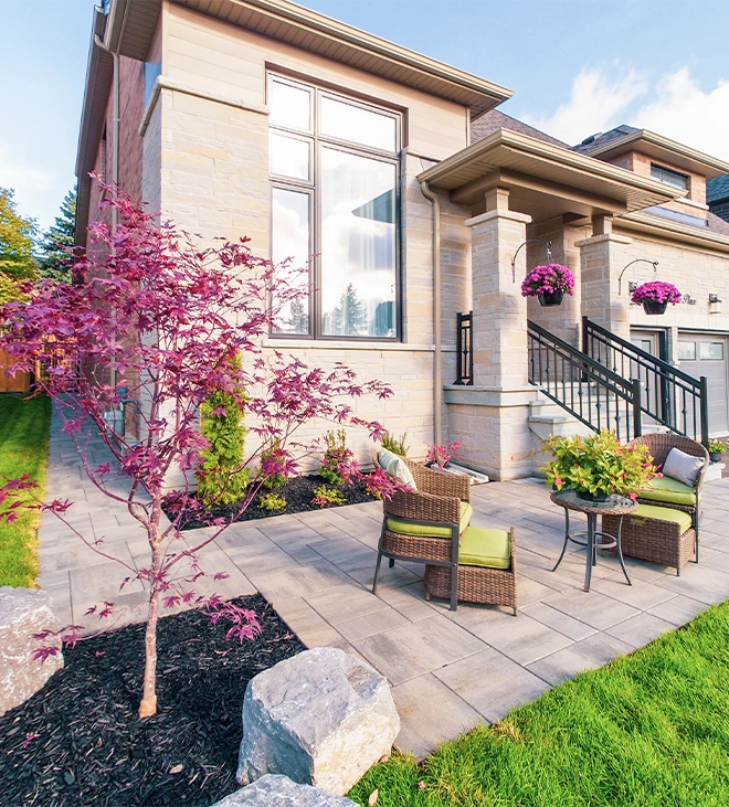 landscaping around patio and seating area in front of home