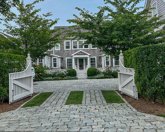 permeable driveway image one luxury home front, permeable driveway and front yard, wooden fence gate, sodding and landscaping