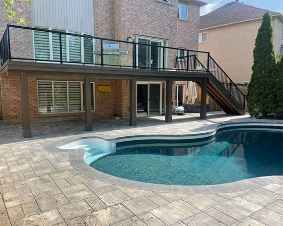 pool deck image one above ground deck with railing and stairs, pool with interlocking deck in home backyard