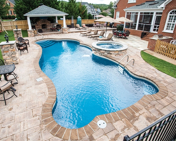 interlocking surface around pool with plunge pool and water feature.