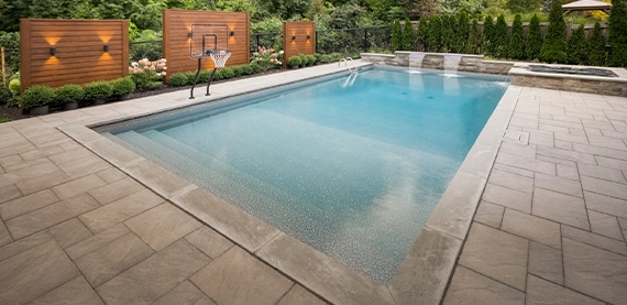 interlocking surface around pool with basketball play setup