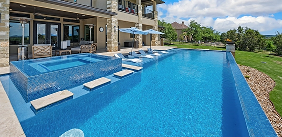infinite pool in front of luxury home yard