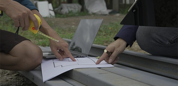 team taking measurement by looking at drawing