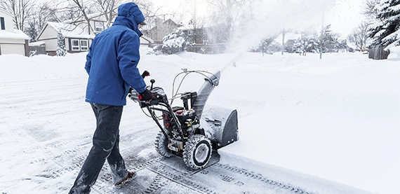 man snow pillowing on residential private road